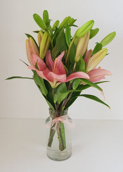 Asiatic Lily In Small Glass Vase.